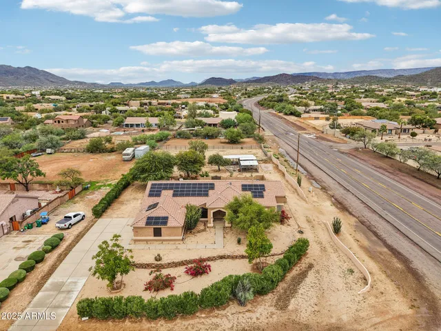 an aerial view of a house with a yard basket ball court and outdoor seating