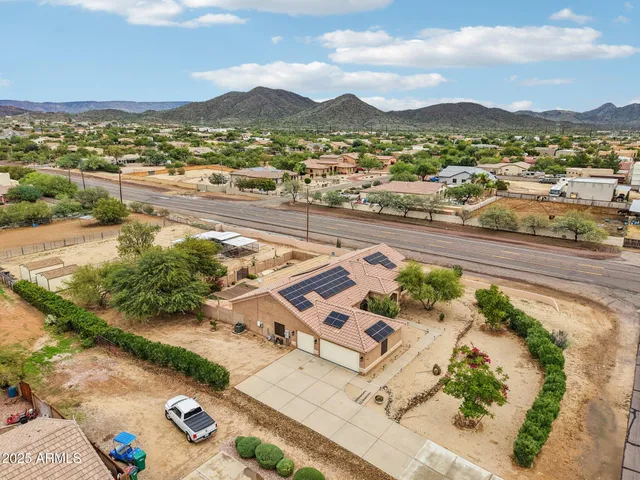 an aerial view of residential houses with outdoor space and city view