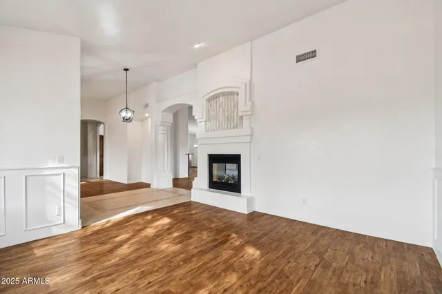 an empty room with fan and windows