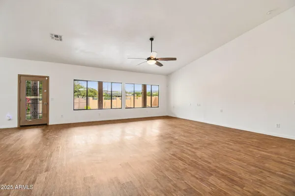 wooden floor in an empty room with a window