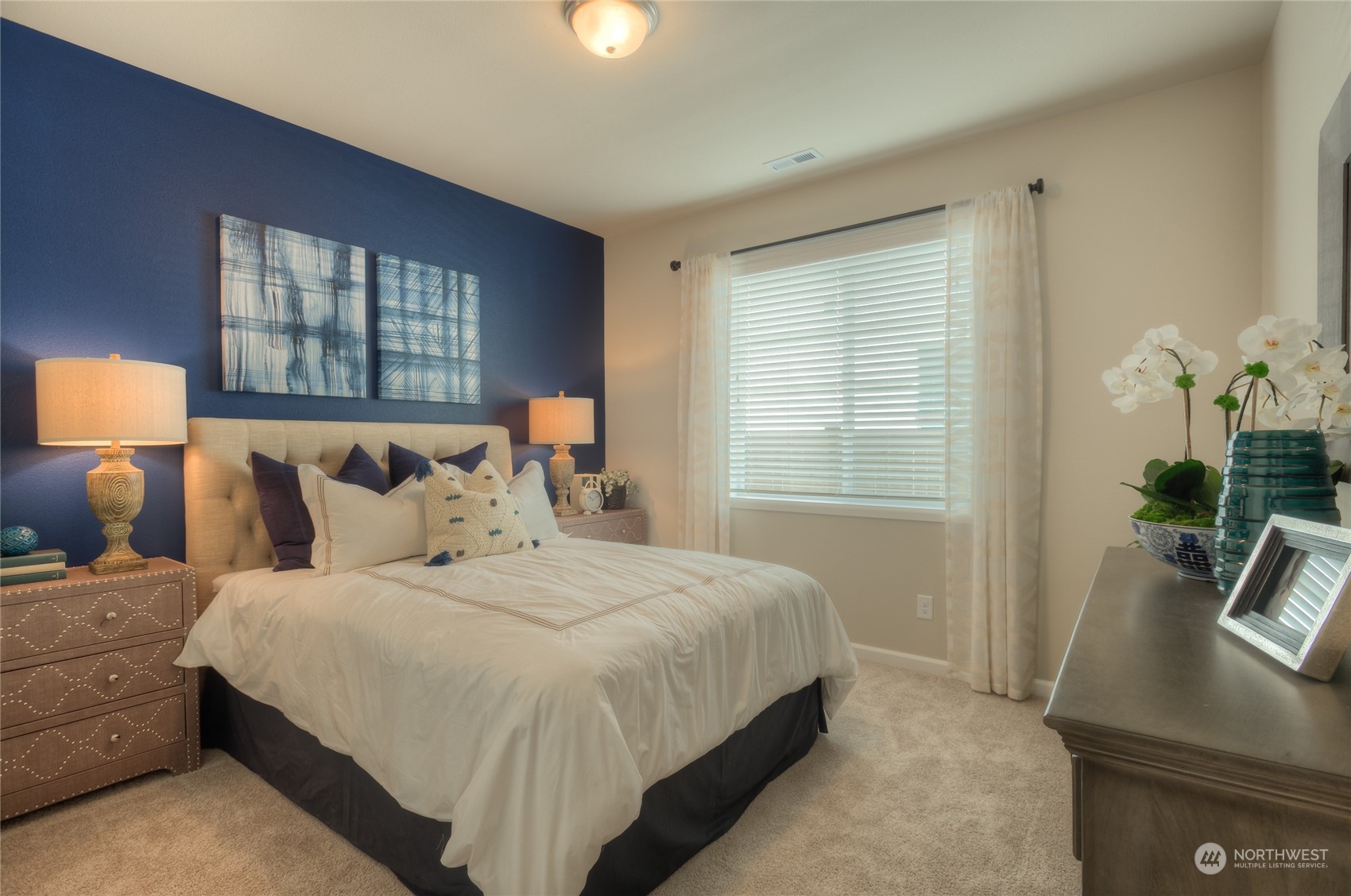 21104 42nd Avenue Southeast, Unit 146 Bothell, WA 98021 - Photo 4 of 25 a bedroom with a bed a mirror and a flat tv screen on dresser