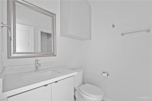 a bathroom with a sink toilet and vanity