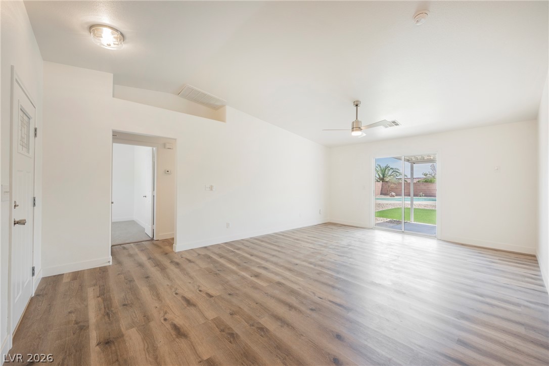 112 Iridescent Street Henderson, NV 89012 - Photo 8 of 24 Hardwood-style flooring and outdoor pool access define this inviting living space.