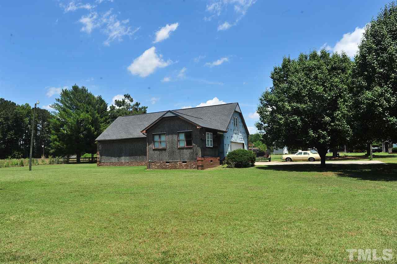 6909 Riley Hill Road Wendell, NC 27591 - Photo 2 of 12 View from Riley Hill Rd. Construction is not complete and will not be completed by seller. Home is sold as is. Roof replaced in 2011. Interior is a shell for buyer to design walls where they want. The Well is dug and ready for new owner to run plumbing.