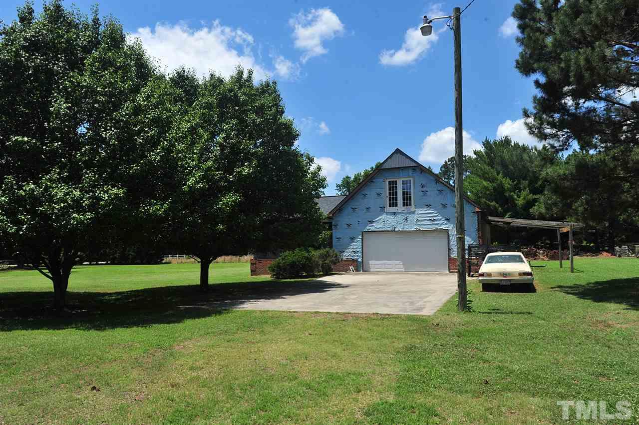 6909 Riley Hill Road Wendell, NC 27591 - Photo 6 of 12 2 car garage and parking pad. Portion of parking pad is on adjacent lot.