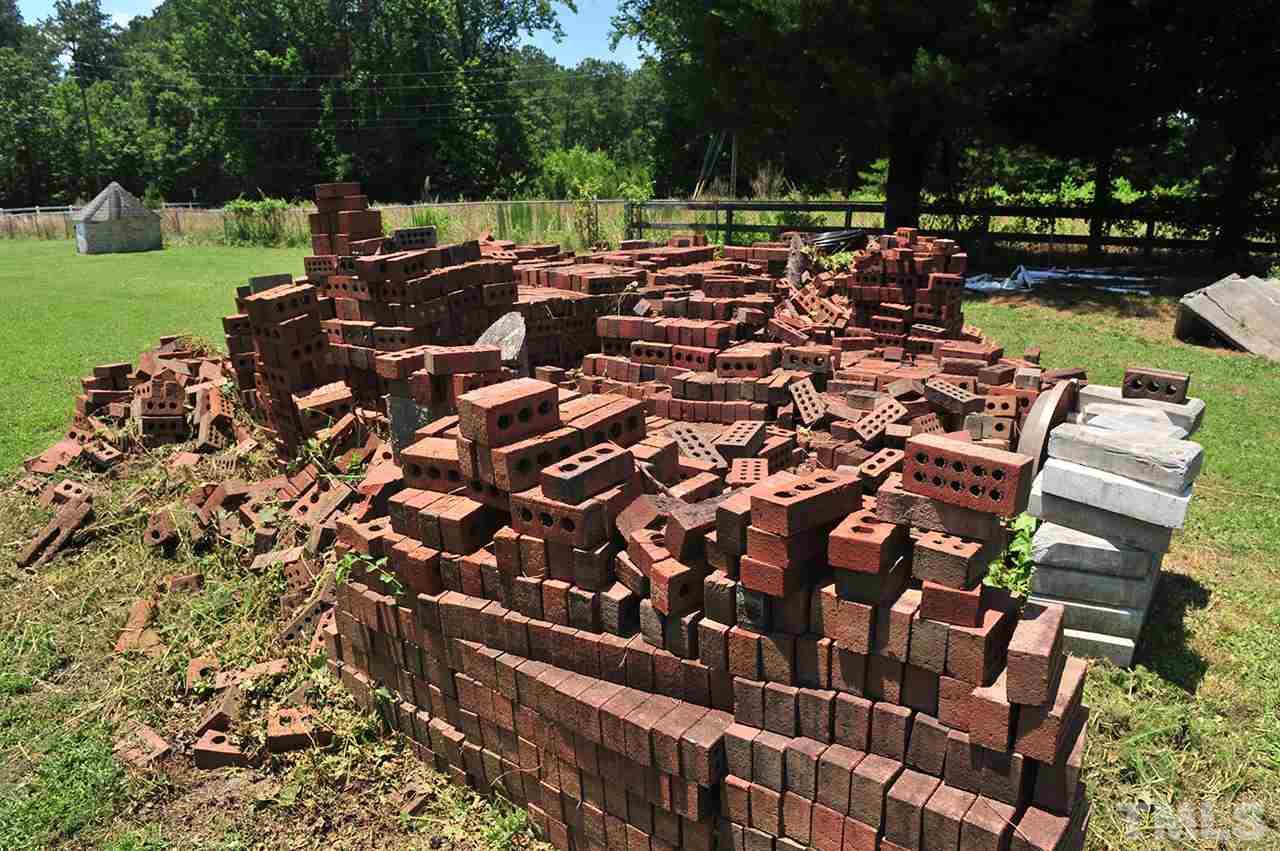 6909 Riley Hill Road Wendell, NC 27591 - Photo 7 of 12 The brick material that is included. The well in upper left of picture is dug and ready for new owner to run plumbing. Permit for septic is initiated and ready for new owner to install.