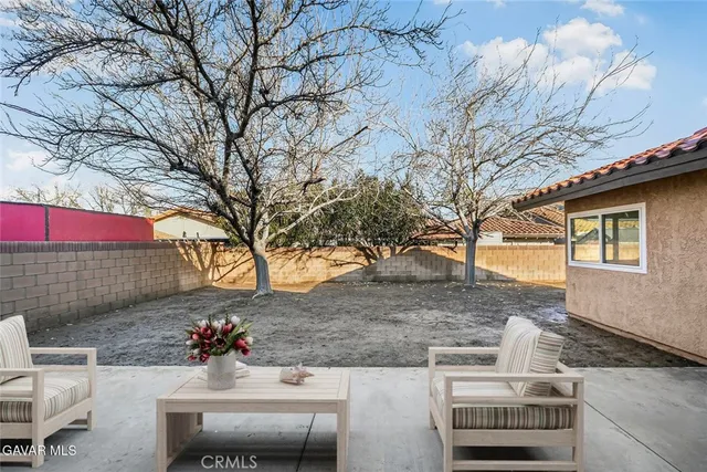 a view of a patio with couches and a fire pit