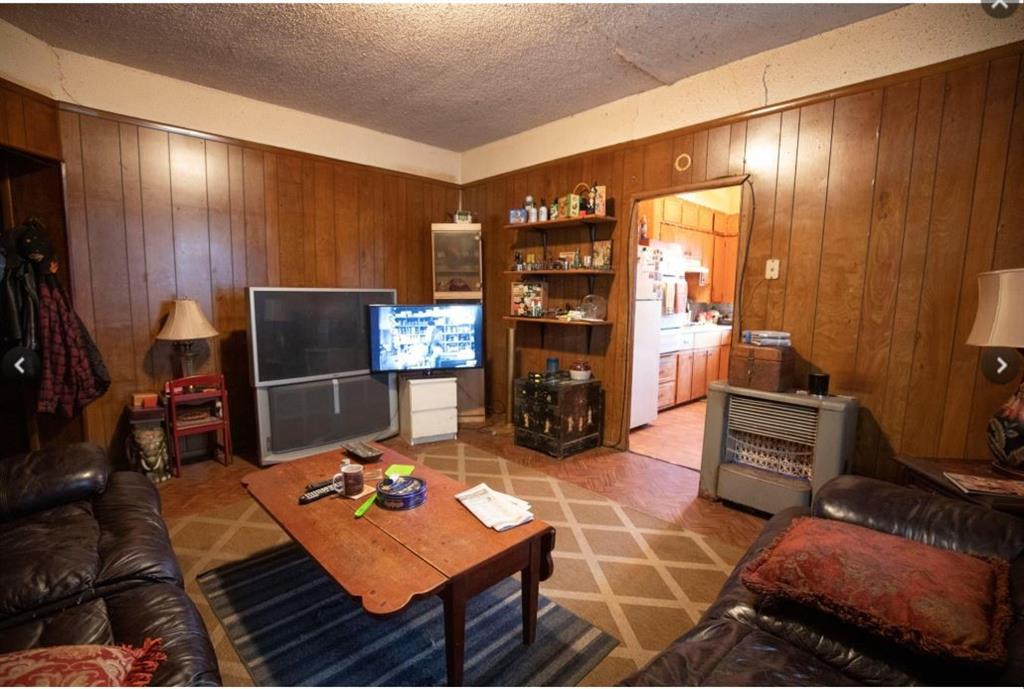 307 West Spruce Street Whitewright, TX 75491 - Photo 4 of 12 a living room with furniture a flat screen tv and a table