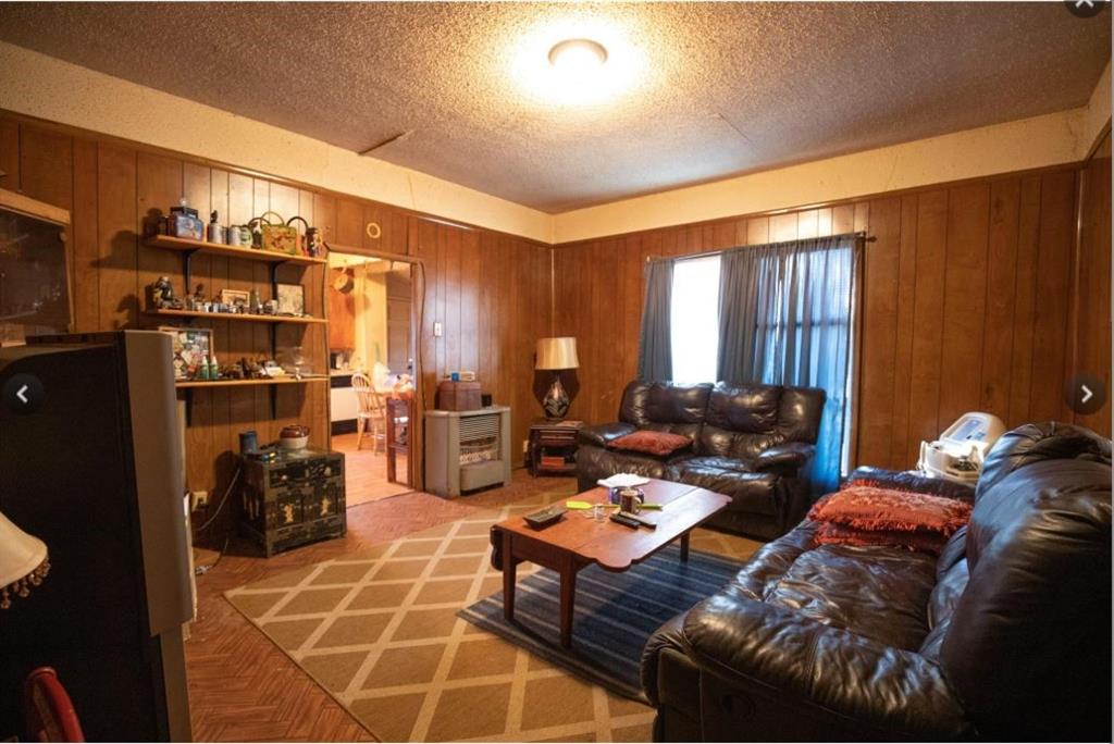 307 West Spruce Street Whitewright, TX 75491 - Photo 5 of 12 a living room with furniture a fireplace and gym equipment