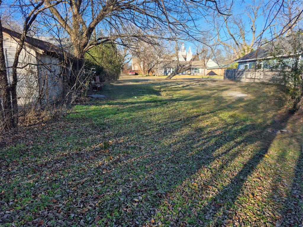307 West Spruce Street Whitewright, TX 75491 - Photo 9 of 12 a view of yard with tree and wooden fence