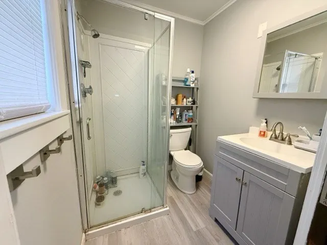 a bathroom with a sink toilet and shower