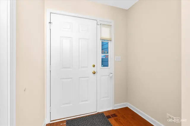 a view of front door with wooden floor