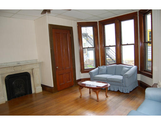 99 Sedgwick Street Boston, MA 02130 - Photo 8 of 14 a living room with furniture and a fireplace