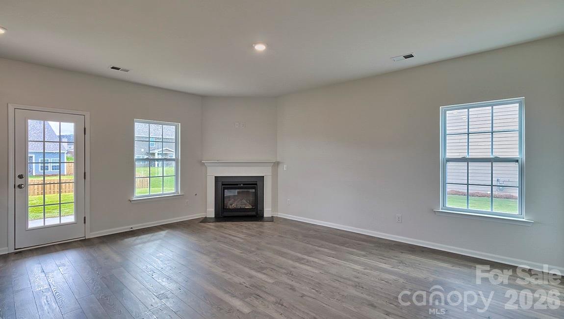 42 Salers Road Fletcher, NC 28732 - Photo 12 of 26 an empty room with windows and fireplace