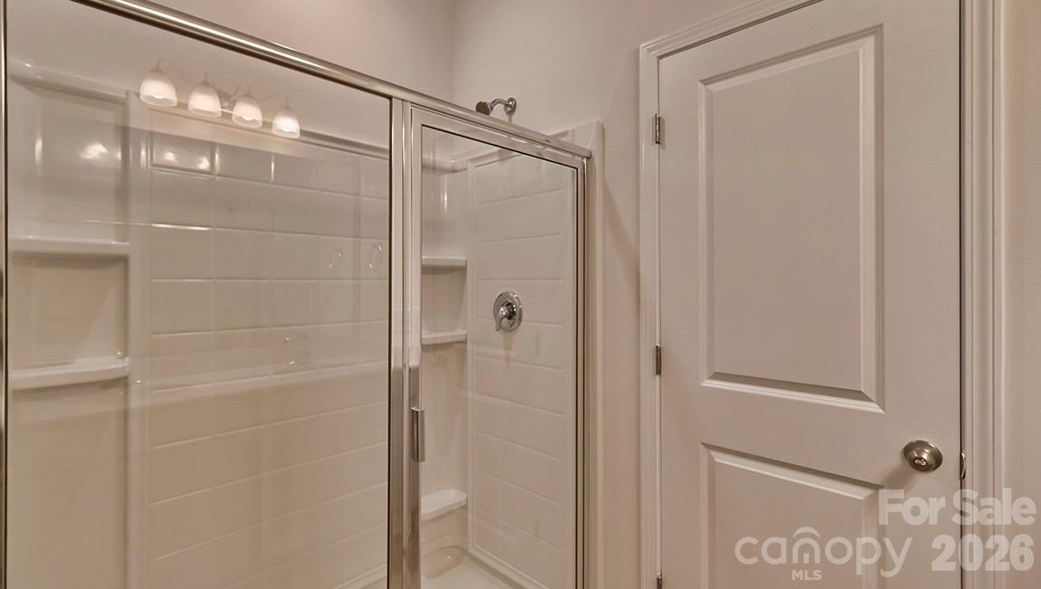 42 Salers Road Fletcher, NC 28732 - Photo 18 of 26 a bathroom with a glass shower door