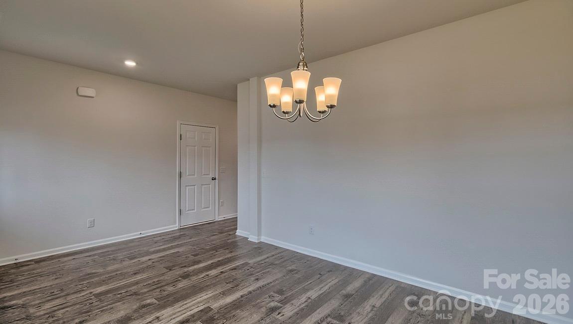 42 Salers Road Fletcher, NC 28732 - Photo 6 of 26 a view of a chandelier fan and wooden floor