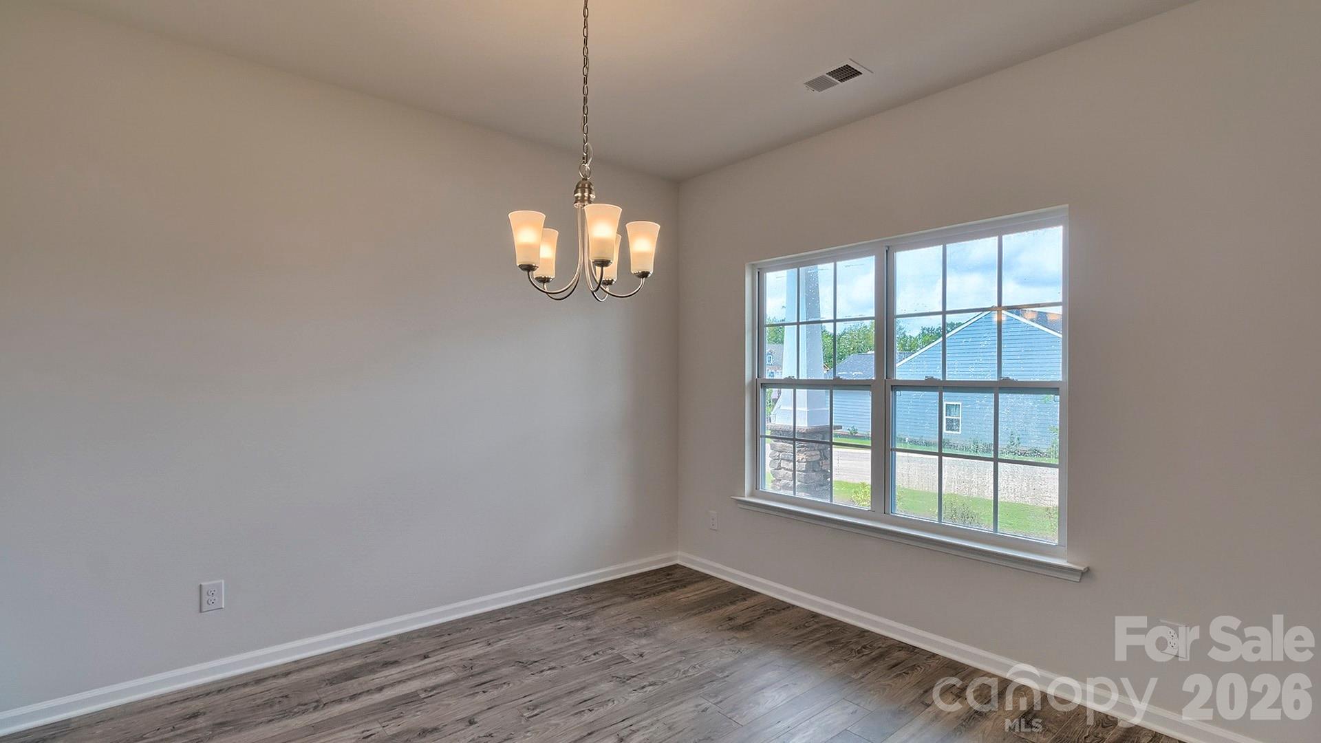 42 Salers Road Fletcher, NC 28732 - Photo 7 of 26 a view of an empty room with wooden floor and a window
