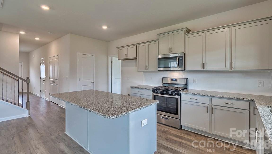 42 Salers Road Fletcher, NC 28732 - Photo 9 of 26 a kitchen with stainless steel appliances granite countertop a stove a sink and a microwave