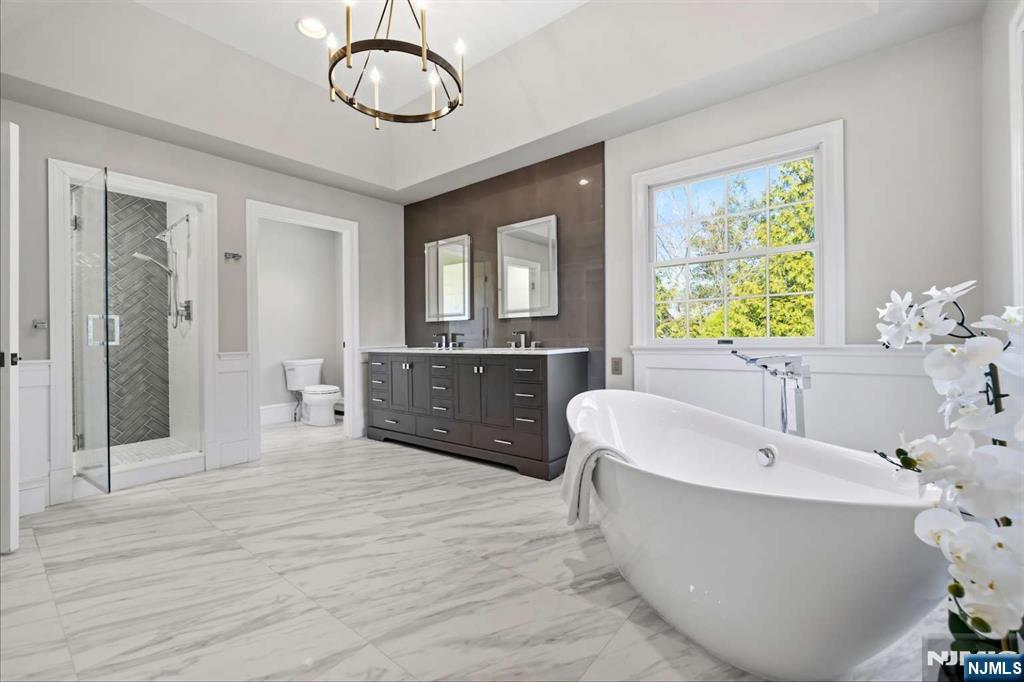 8 Wainwright Court Closter, NJ 07624 - Photo 14 of 29 a spacious bathroom with a tub sink and mirror