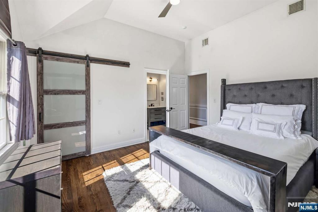 8 Wainwright Court Closter, NJ 07624 - Photo 19 of 29 a bedroom with a bed and a large mirror on the dresser