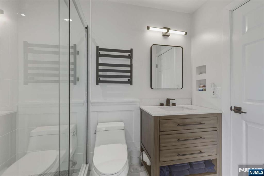 8 Wainwright Court Closter, NJ 07624 - Photo 21 of 29 a bathroom with a toilet sink and mirror