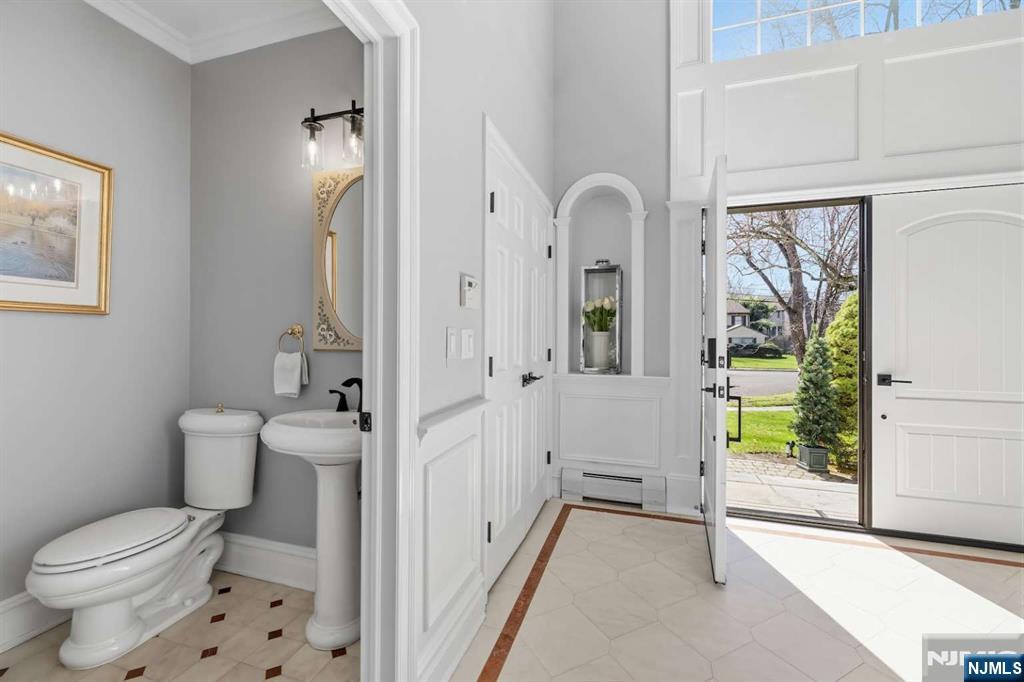 8 Wainwright Court Closter, NJ 07624 - Photo 4 of 29 a bathroom with a granite countertop toilet a sink and a window