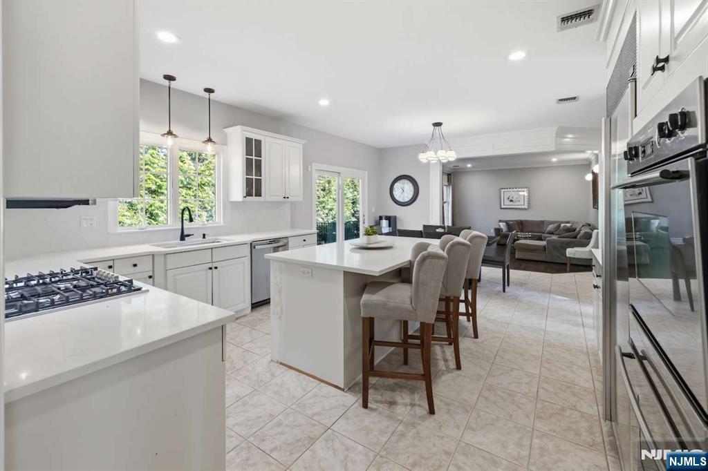 8 Wainwright Court Closter, NJ 07624 - Photo 6 of 29 a kitchen with a sink and chairs