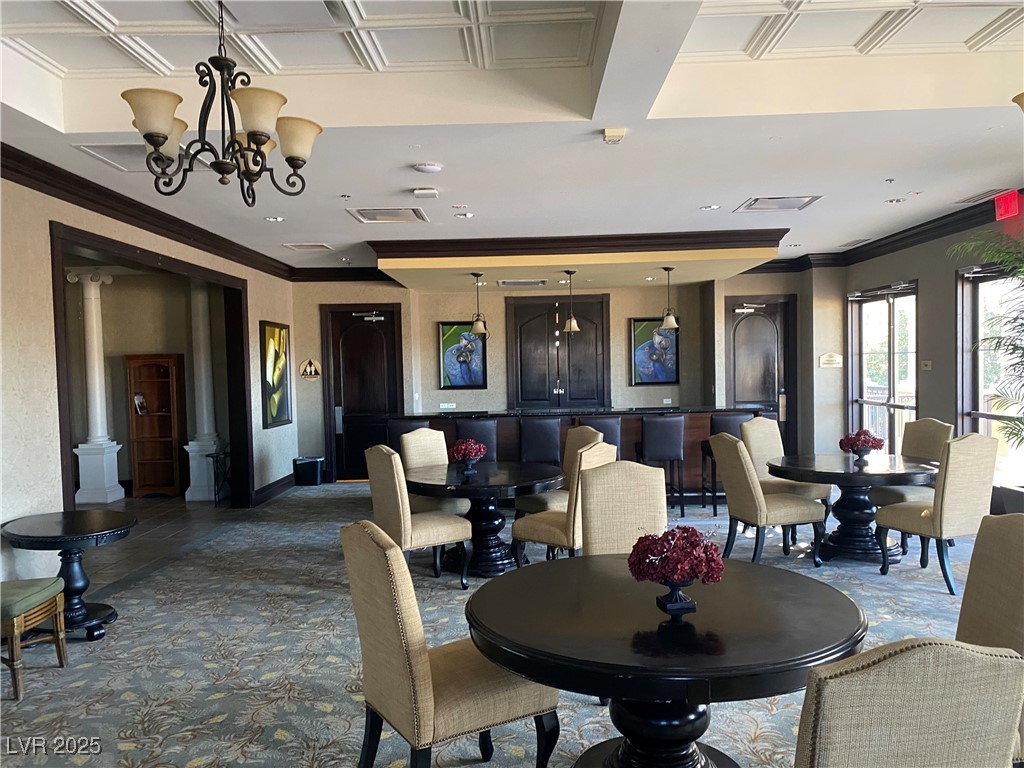 2405 West Serene Avenue, Unit 827 Las Vegas, NV 89123 - Photo 26 of 48 Dining area with ornamental molding and a chandelier