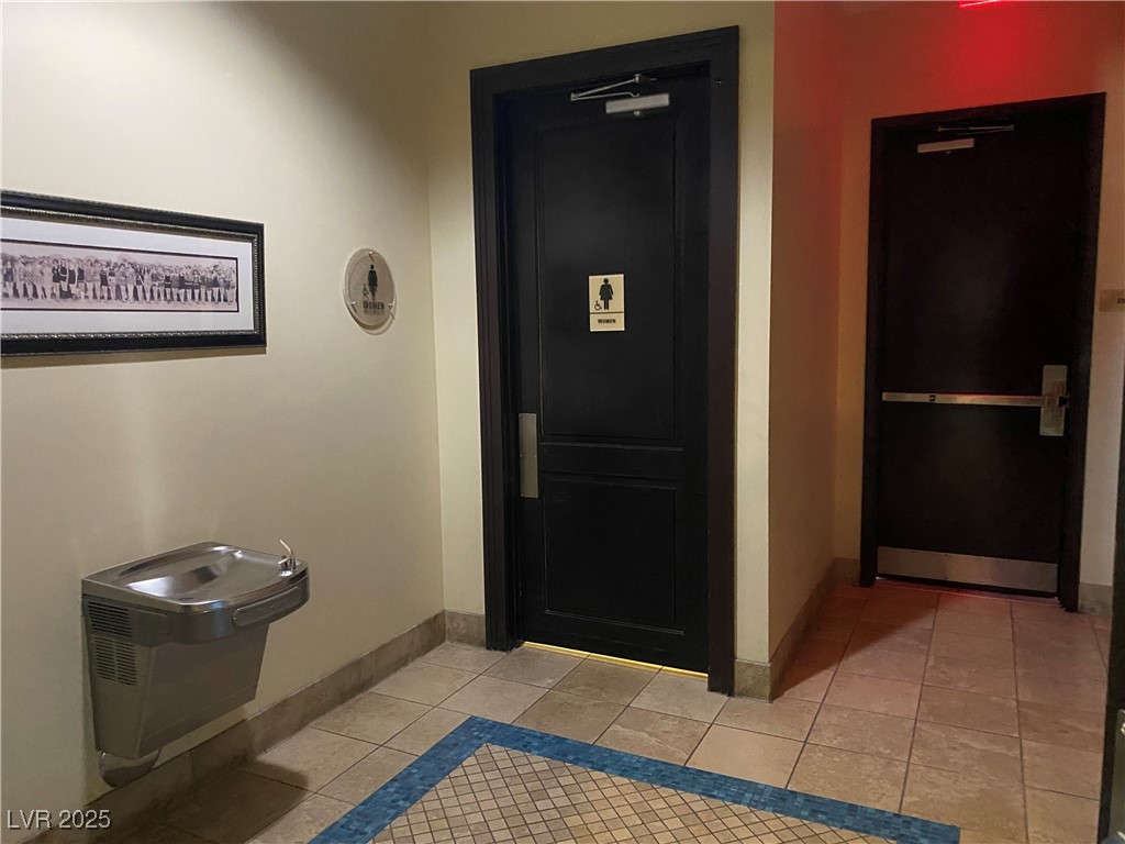 2405 West Serene Avenue, Unit 827 Las Vegas, NV 89123 - Photo 31 of 48 Hall featuring light tile patterned floors and baseboards