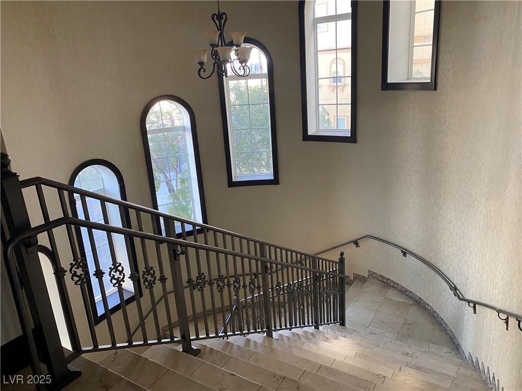 2405 West Serene Avenue, Unit 827 Las Vegas, NV 89123 - Photo 32 of 48 Staircase with a chandelier