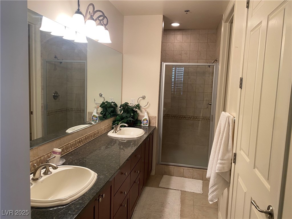 2405 West Serene Avenue, Unit 827 Las Vegas, NV 89123 - Photo 45 of 48 Full bathroom featuring double vanity, a stall shower, light tile patterned floors, and recessed lighting