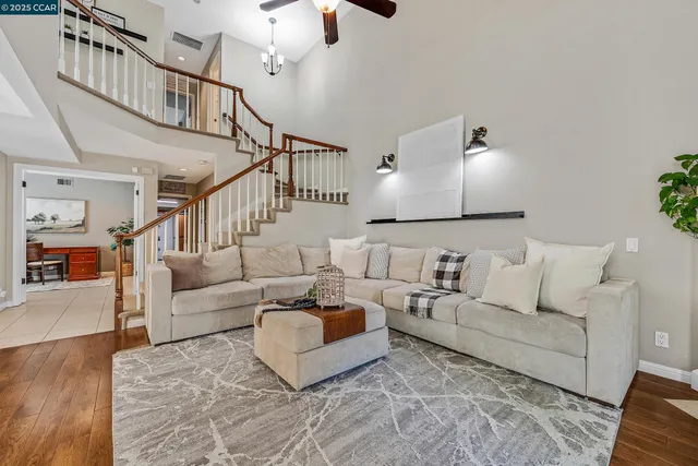 a living room with furniture and a chandelier