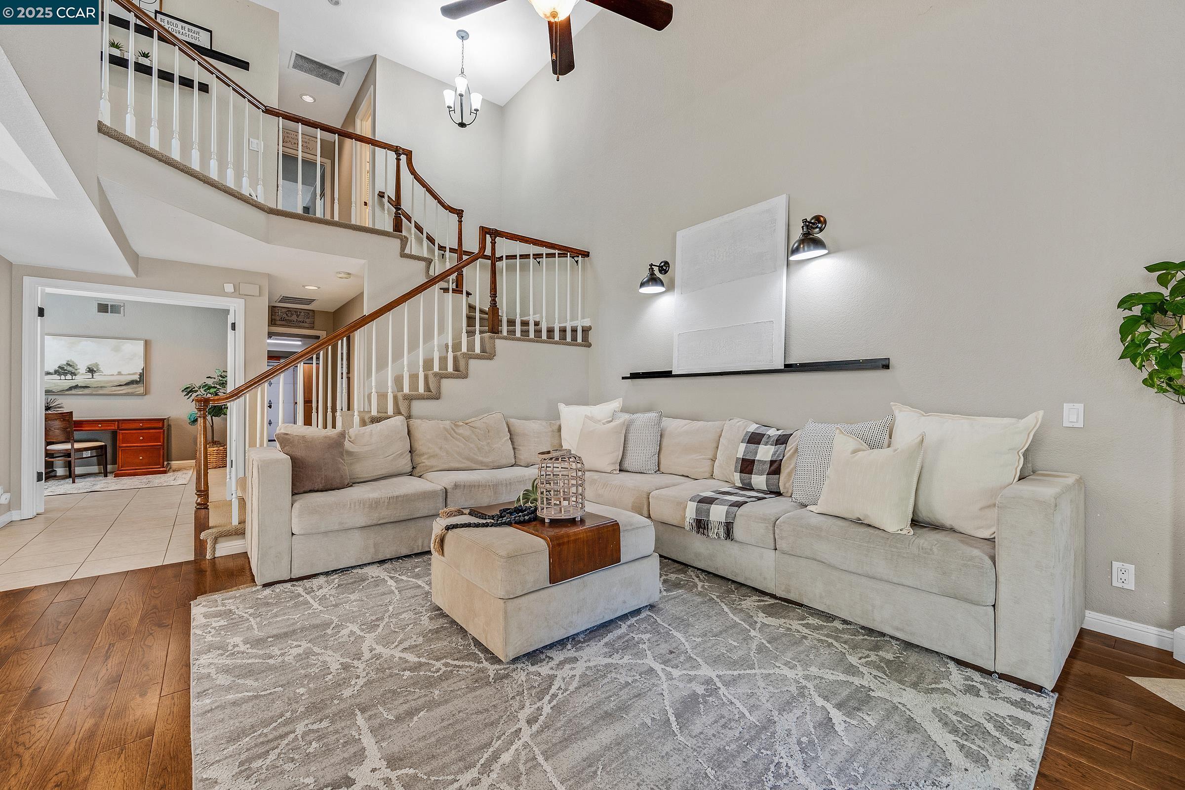 a living room with furniture and a chandelier