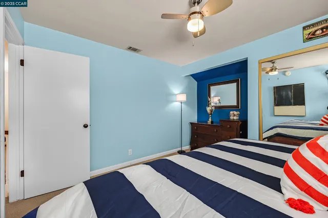 a bedroom with bed and wooden floor