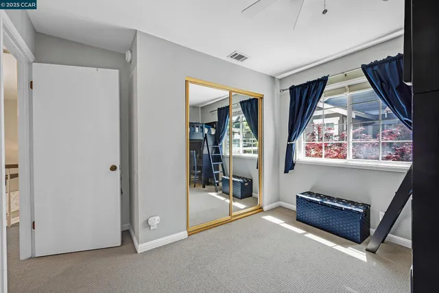 a living room with a window and gym equipment