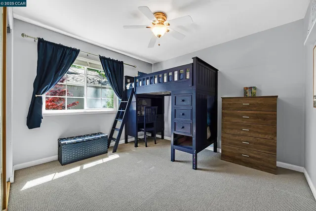 a view of room with furniture and a ceiling fan