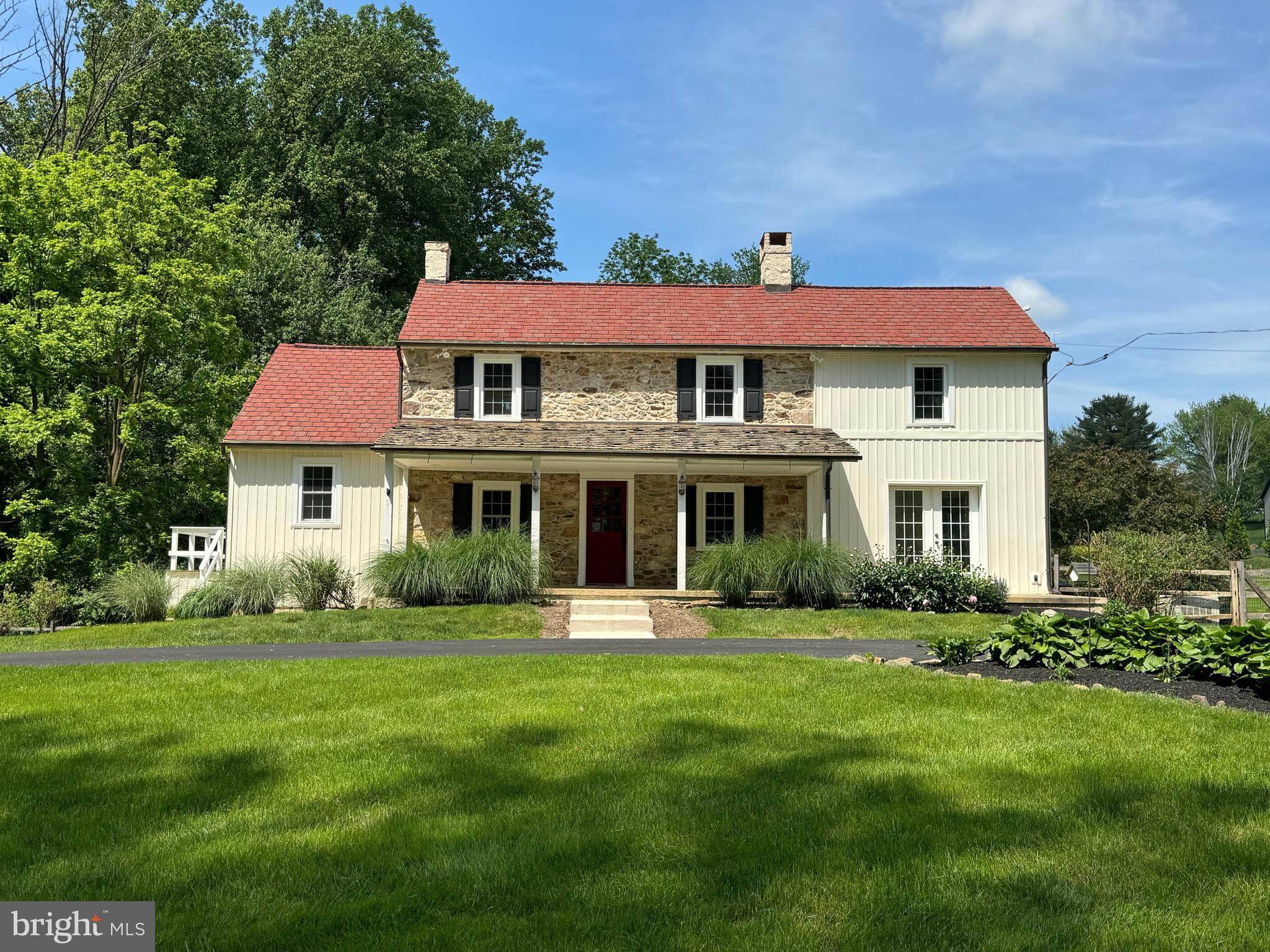 a front view of a house with a garden
