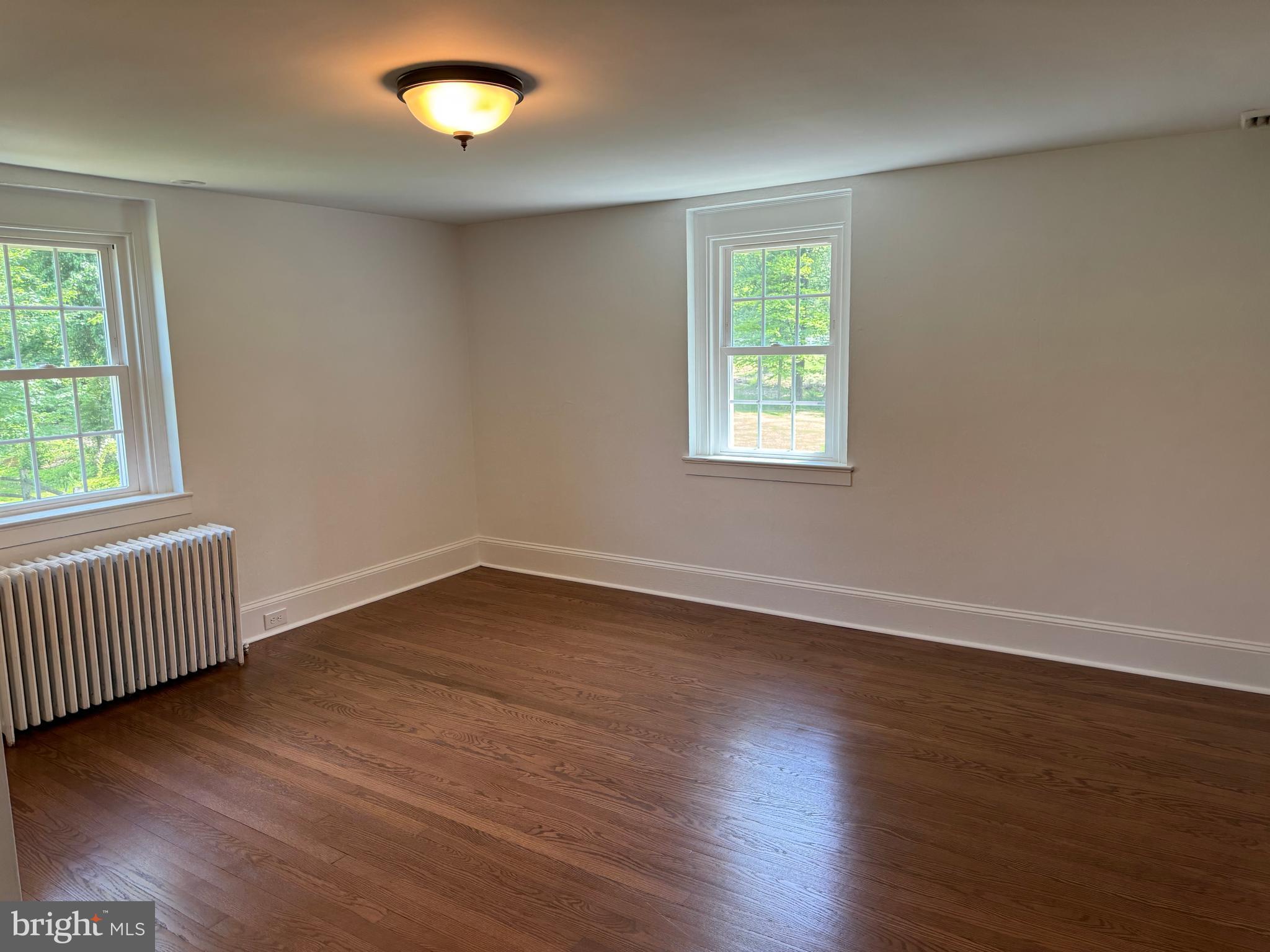553 Worthington Road Chester Springs, PA 19425 - Photo 13 of 33 a view of an empty room with wooden floor and a window