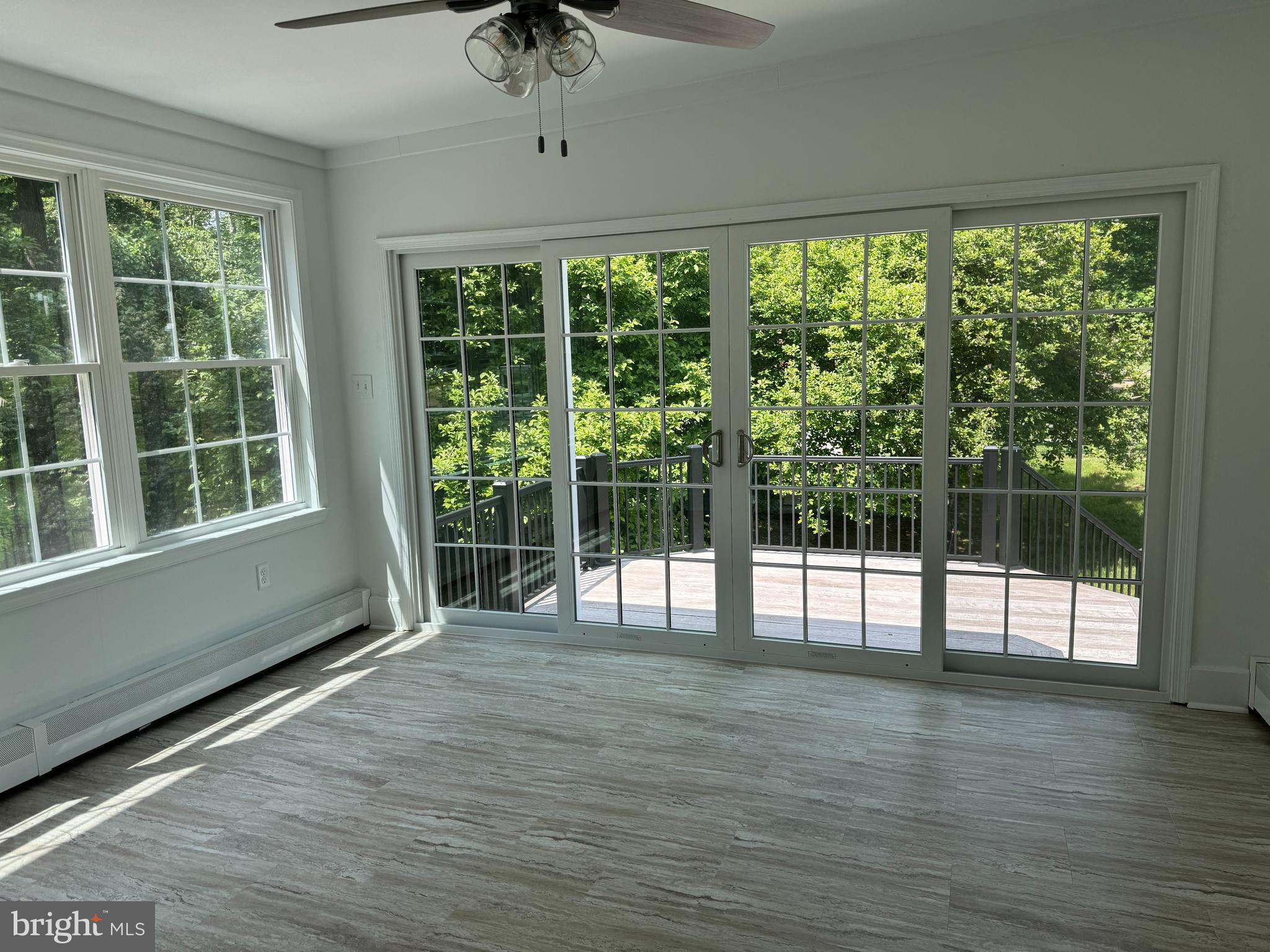 553 Worthington Road Chester Springs, PA 19425 - Photo 7 of 33 a view of an empty room with wooden floor and a window