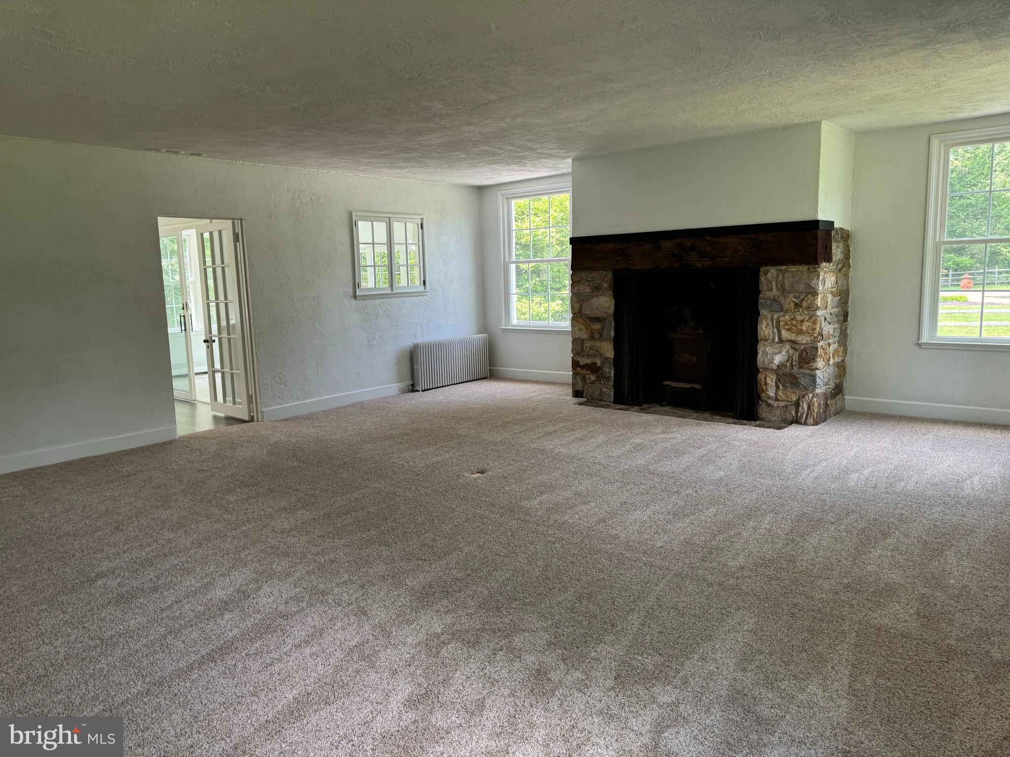 553 Worthington Road Chester Springs, PA 19425 - Photo 9 of 33 a big room with windows and a fireplace