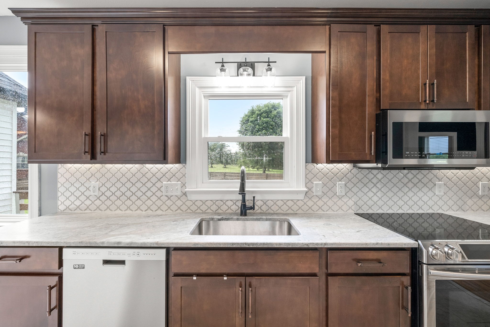 4921 Sango Road Clarksville, TN 37043 - Photo 16 of 52 a kitchen with granite countertop a sink and a window