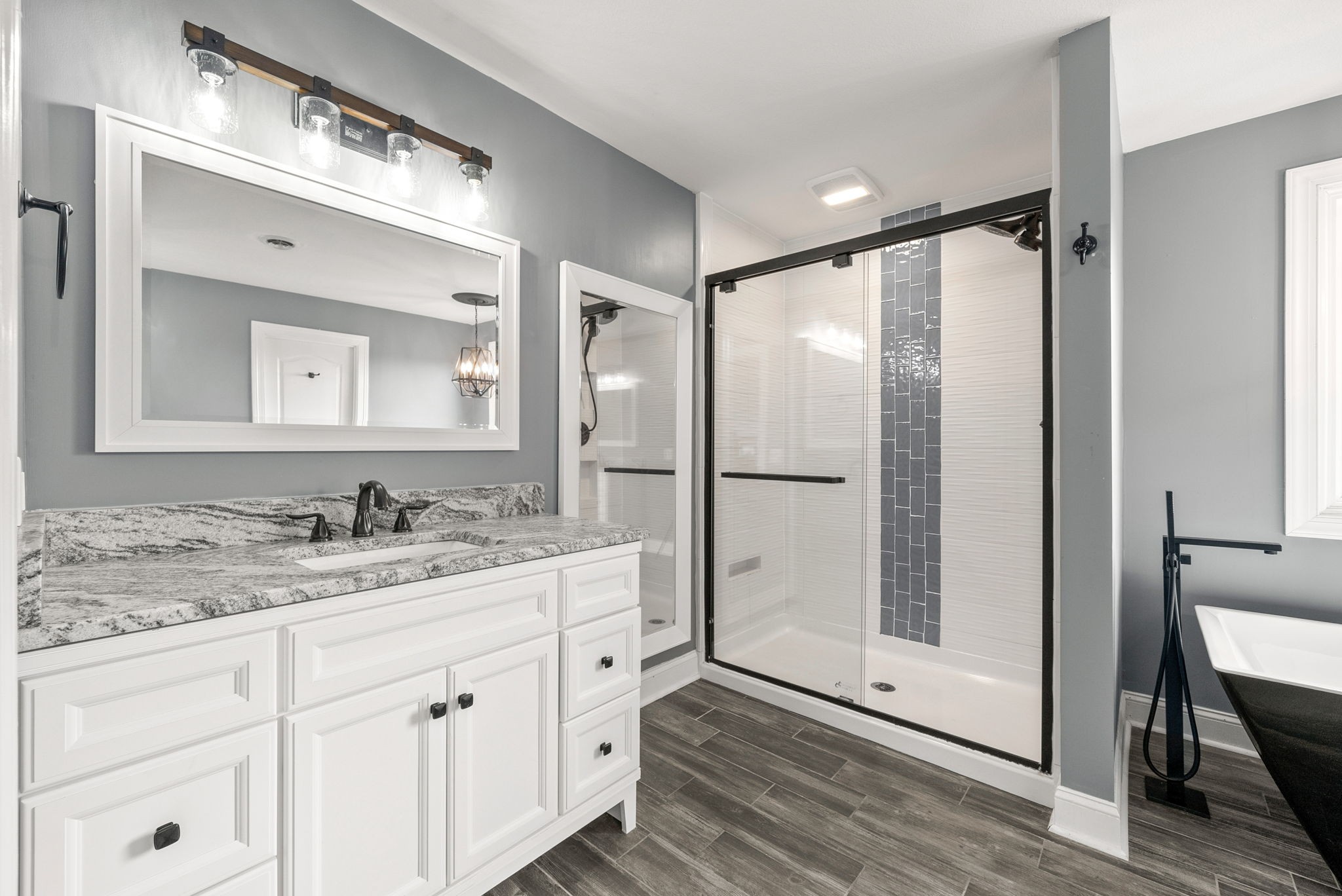 4921 Sango Road Clarksville, TN 37043 - Photo 27 of 52 a bathroom with a double vanity sink mirror and shower