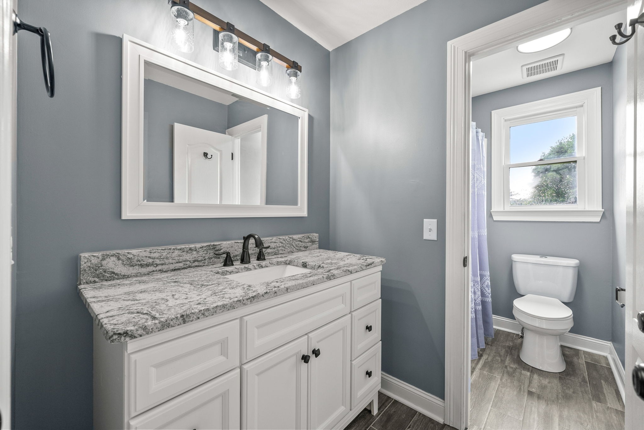4921 Sango Road Clarksville, TN 37043 - Photo 45 of 52 a bathroom with a granite countertop sink a toilet and a mirror