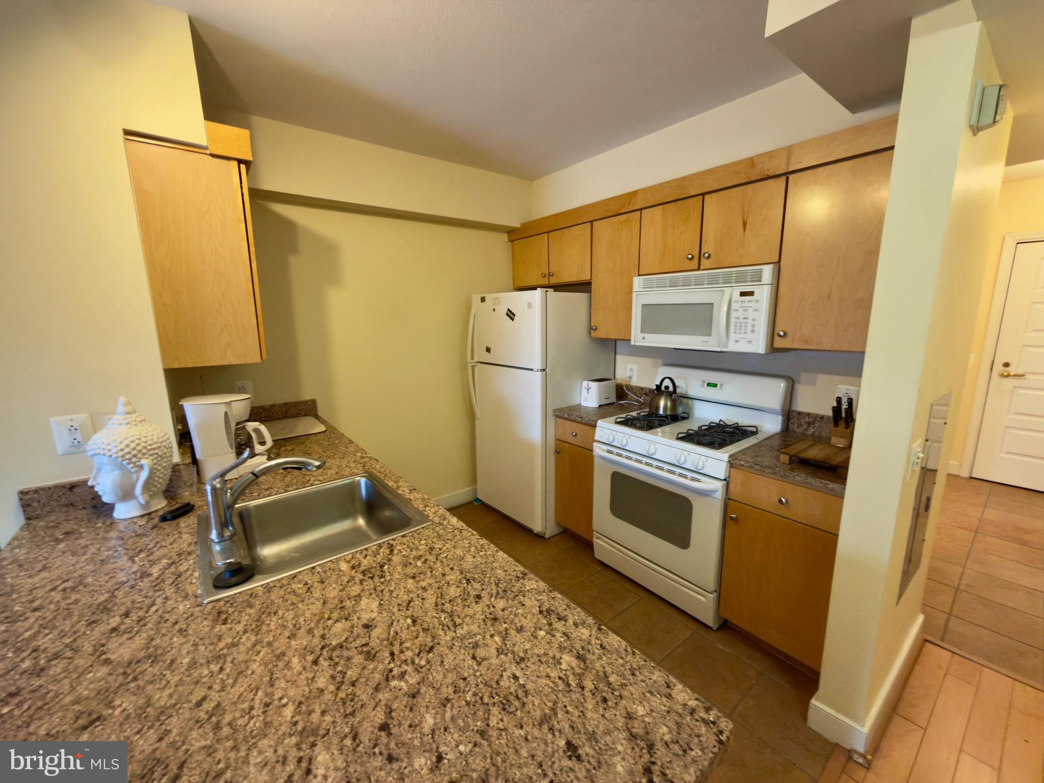 631 D Street Northwest, Unit 1038 Washington, DC 20004 - Photo 12 of 56 a kitchen with stainless steel appliances granite countertop a stove a sink and a refrigerator