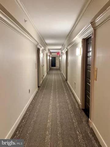 a view of hallway with wooden floor