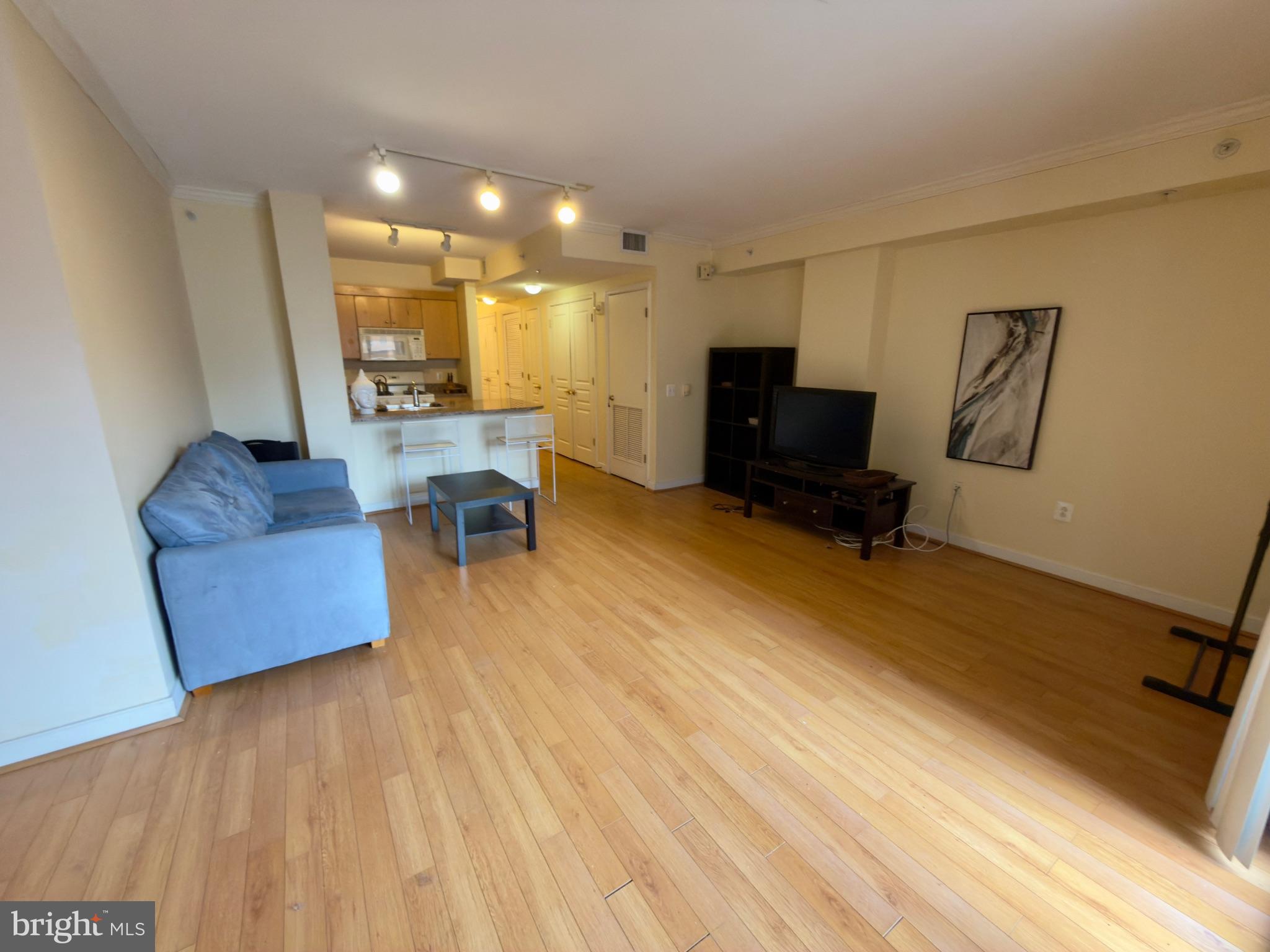 631 D Street Northwest, Unit 1038 Washington, DC 20004 - Photo 7 of 56 a living room with furniture and a flat screen tv