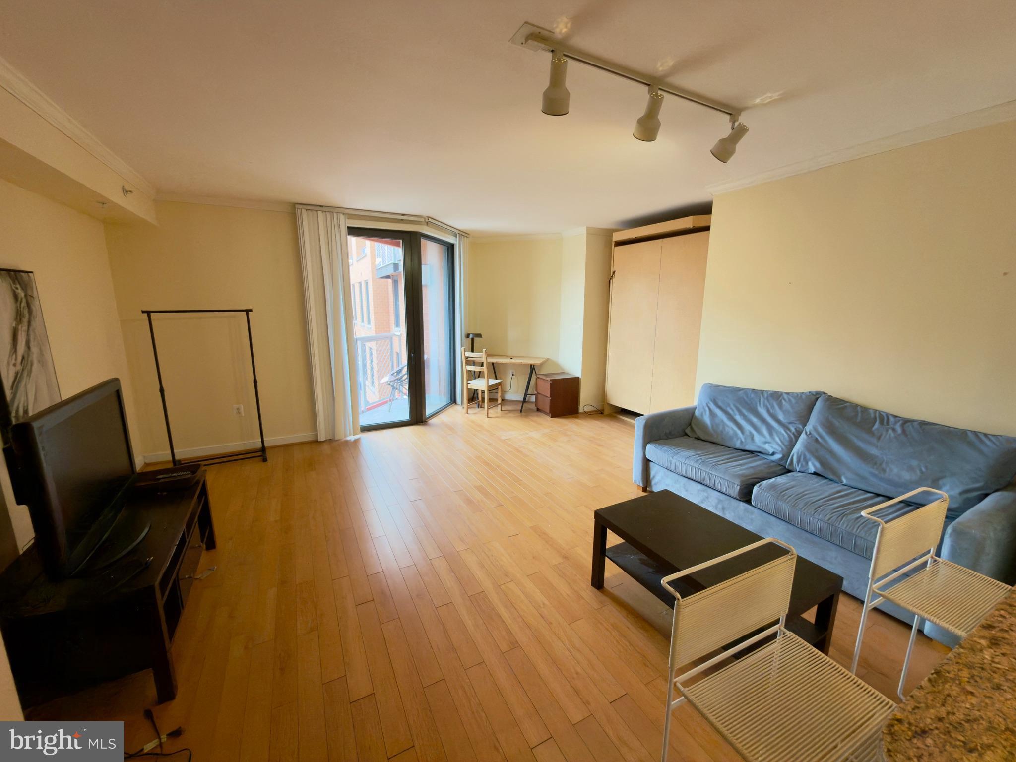 631 D Street Northwest, Unit 1038 Washington, DC 20004 - Photo 10 of 56 a living room with furniture and a flat screen tv