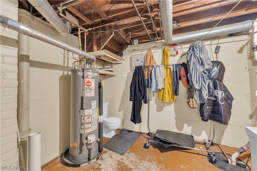3962 Grosvenor Road South Euclid, OH 44118 - Photo 24 of 27 Basement utility area featuring exposed wood joists and ductwork, a water heater, and a toilet