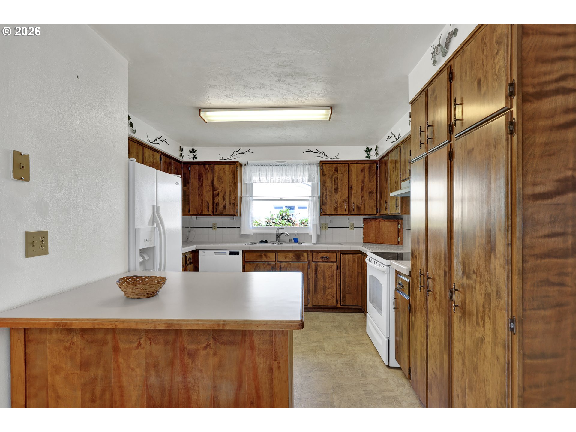 1425 Taney Street Eugene, OR 97402 - Photo 11 of 34 a kitchen with stainless steel appliances granite countertop a refrigerator a sink dishwasher with a dining table and chairs