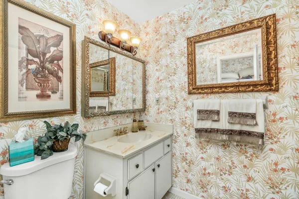 a bathroom with a sink mirror and vanity